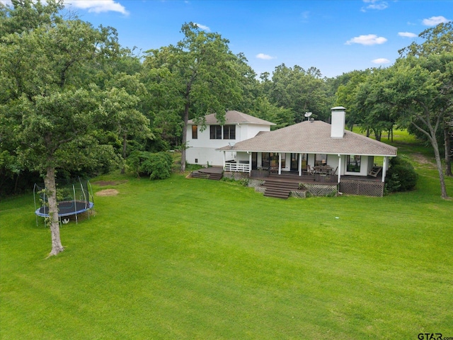 7016 Fm 3054, Malakoff, TX 75148 - rear view of property with a trampoline, a lawn, a chimney, and a shingled roof