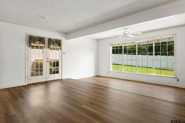 empty room featuring french doors, ceiling fan, dark hardwood / wood-style flooring, and a textured ceiling