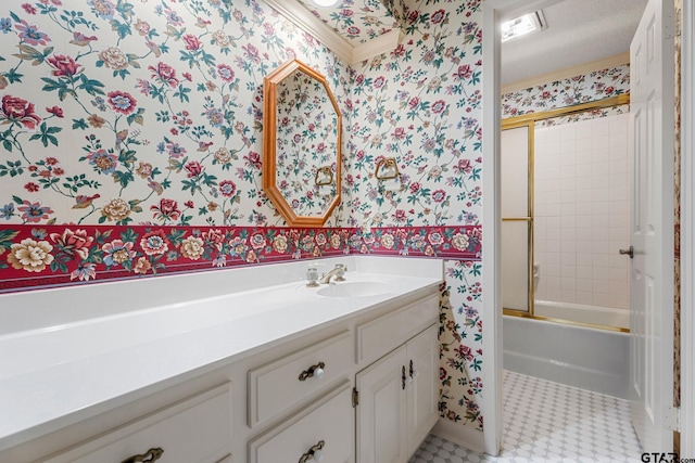 bathroom featuring a textured ceiling, vanity, bath / shower combo with glass door, and tile patterned flooring