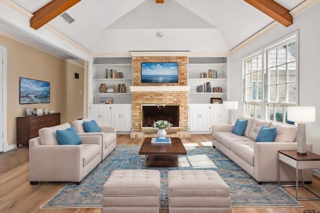 living room featuring hardwood / wood-style floors, vaulted ceiling with beams, ornamental molding, and a fireplace