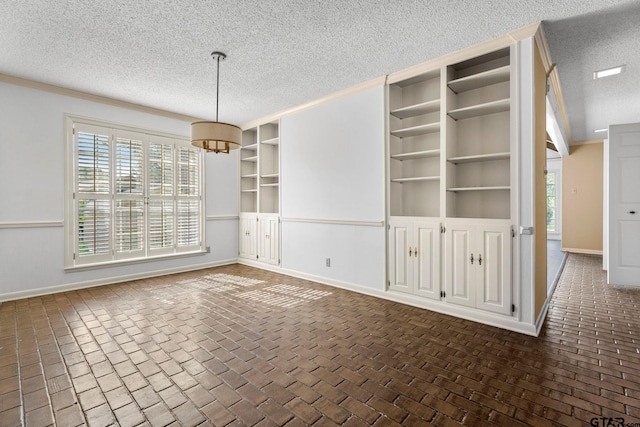 unfurnished dining area featuring a textured ceiling