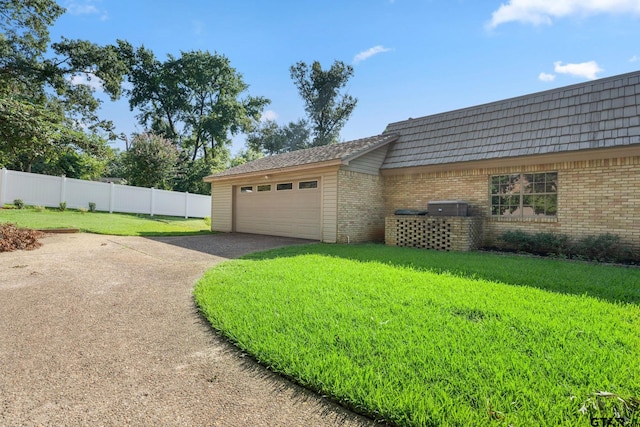 view of property exterior featuring a yard and a garage