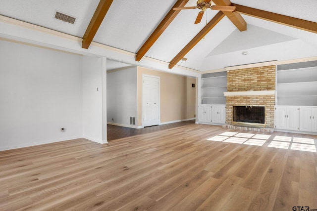 unfurnished living room with vaulted ceiling with beams, a brick fireplace, ceiling fan, and light wood-type flooring