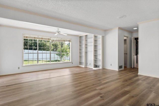 unfurnished living room featuring a textured ceiling, hardwood / wood-style flooring, ceiling fan, and ornamental molding