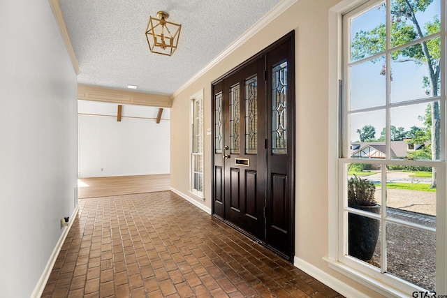 interior space featuring crown molding and a textured ceiling