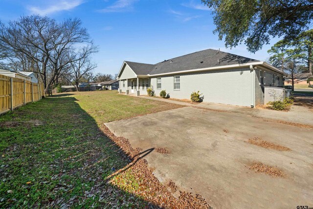 rear view of house with a patio area and a yard