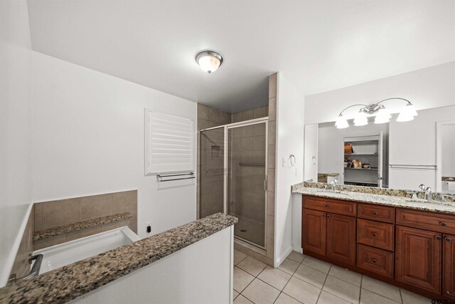 bathroom featuring tile patterned flooring, vanity, and an enclosed shower