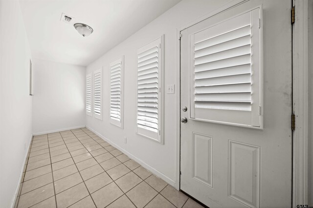 entryway with light tile patterned floors