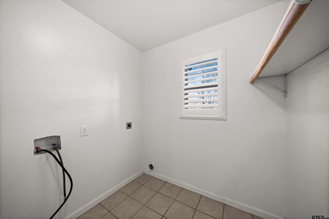 laundry area with hookup for an electric dryer, washer hookup, and light tile patterned floors