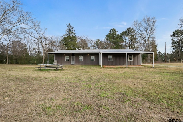 back of property featuring a yard