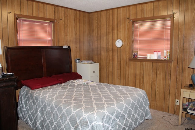 bedroom featuring crown molding, carpet flooring, and wood walls