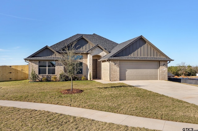 view of front of house with a front yard and a garage