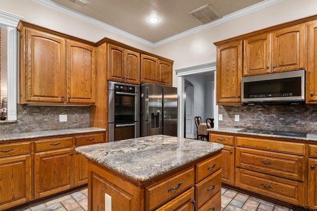3631 River Oaks Ct, Tyler, TX 75707 - kitchen with stainless steel appliances, ornamental molding, decorative backsplash, and brown cabinetry