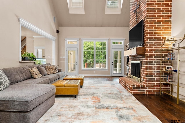 3631 River Oaks Ct, Tyler, TX 75707 - living room with hardwood / wood-style floors, high vaulted ceiling, and a brick fireplace
