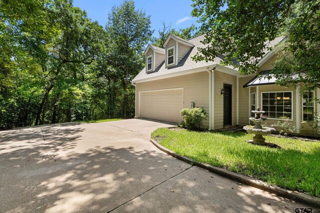 3631 River Oaks Ct, Tyler, TX 75707 - view of property exterior featuring driveway, an attached garage, and roof with shingles