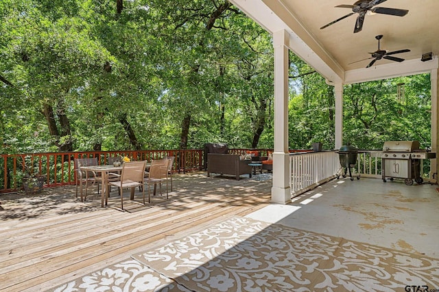 3631 River Oaks Ct, Tyler, TX 75707 - wooden terrace with outdoor dining area, area for grilling, ceiling fan, and view of wooded area