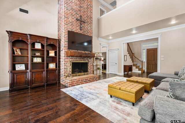 3631 River Oaks Ct, Tyler, TX 75707 - living area featuring ornamental molding, hardwood / wood-style flooring, a high ceiling, stairs, and baseboards