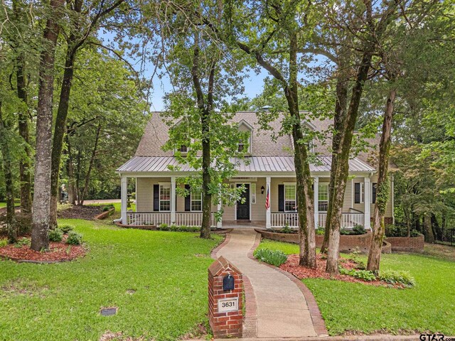 3631 River Oaks Ct, Tyler, TX 75707 - cape cod home featuring covered porch, a front lawn, metal roof, and a standing seam roof
