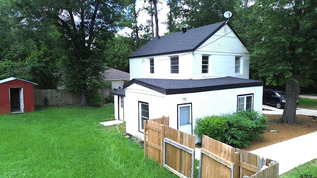 301 Harold St, Crockett, TX 75835 - view of front of house featuring roof with shingles and a storage unit