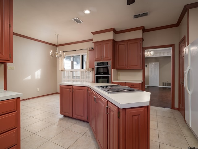 kitchen with appliances with stainless steel finishes, a center island, crown molding, and a chandelier