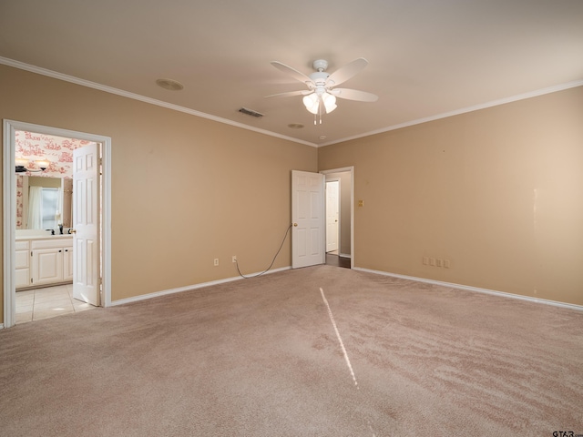 spare room featuring ceiling fan, ornamental molding, and light carpet