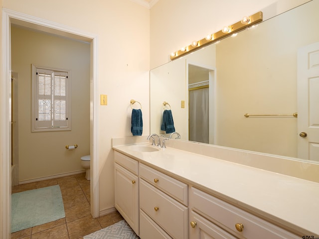 bathroom featuring toilet, curtained shower, tile patterned floors, and vanity