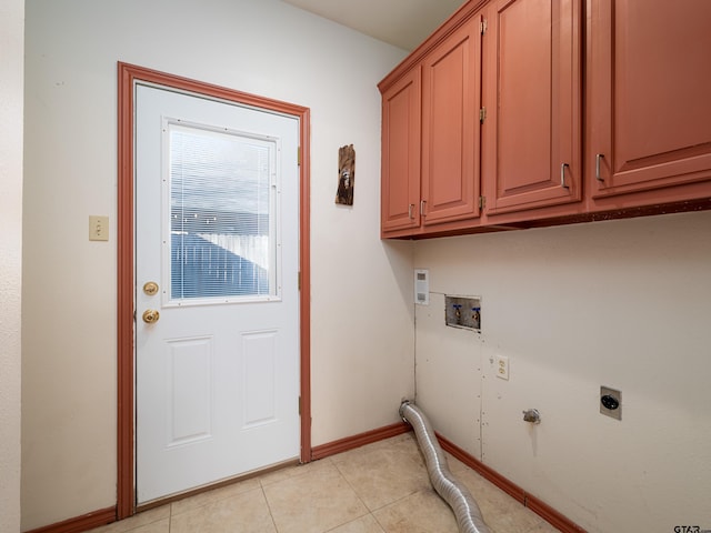 washroom with washer hookup, cabinets, hookup for an electric dryer, light tile patterned floors, and gas dryer hookup