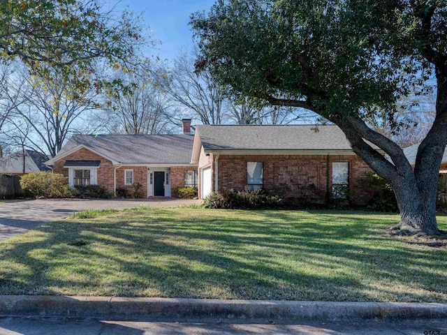 ranch-style house featuring a front lawn and a garage