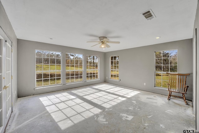 unfurnished sunroom with visible vents and ceiling fan