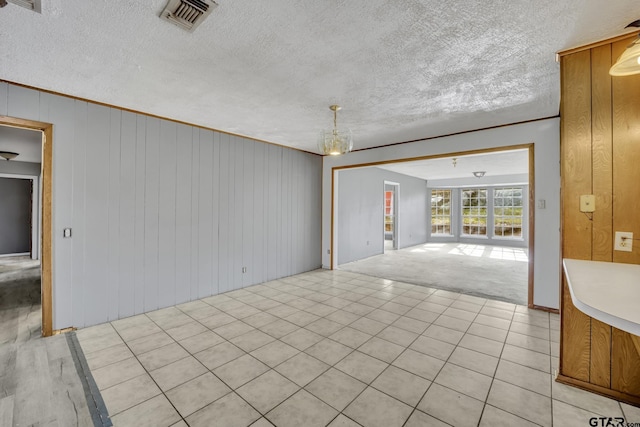 empty room with visible vents and a textured ceiling