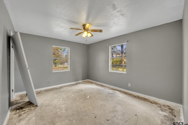 unfurnished bedroom with baseboards, a textured ceiling, and a ceiling fan