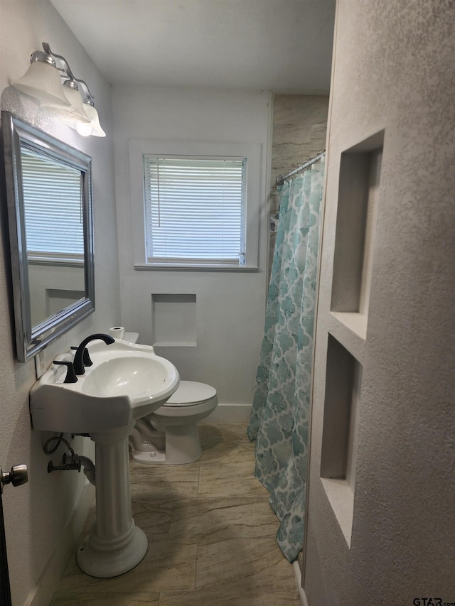216 Mattison St, Pittsburg, TX 75686 - bathroom featuring a shower with shower curtain and wood finished floors