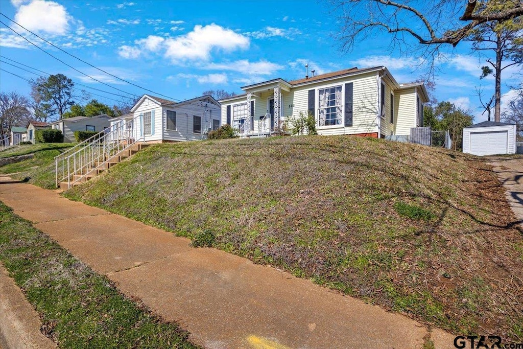 ranch-style home featuring a garage and a front yard