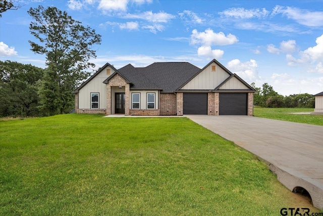 view of front of house featuring an attached garage, a front lawn, board and batten siding, brick siding, and driveway