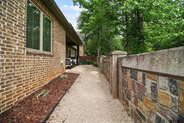 7863 Cross Rd, Tyler, TX 75703 - view of side of home with brick siding and fence