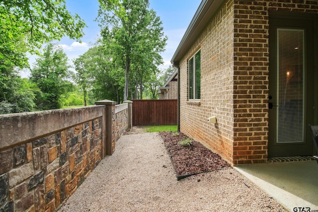 7863 Cross Rd, Tyler, TX 75703 - view of side of property featuring brick siding and fence