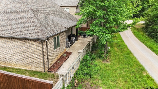 7863 Cross Rd, Tyler, TX 75703 - view of home's exterior with a shingled roof and brick siding