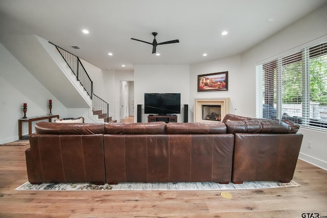 7863 Cross Rd, Tyler, TX 75703 - living room with ceiling fan, recessed lighting, light wood-style flooring, baseboards, and stairway