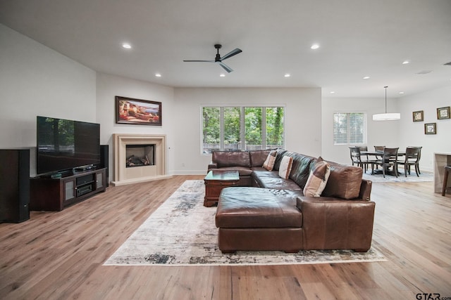 7863 Cross Rd, Tyler, TX 75703 - living area featuring light wood-style floors, recessed lighting, a fireplace, ceiling fan, and baseboards