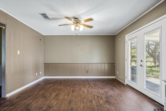 unfurnished room with a textured ceiling, french doors, dark hardwood / wood-style floors, and ceiling fan