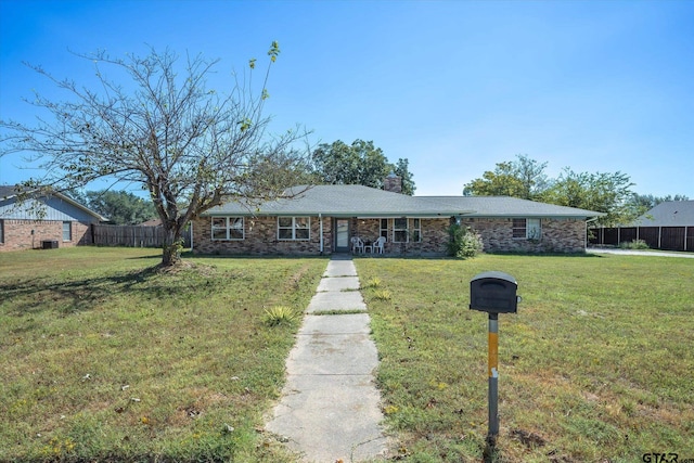 ranch-style home with a front lawn