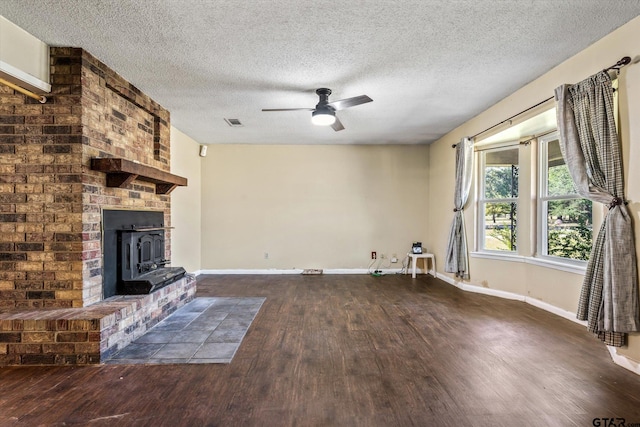 unfurnished living room with dark wood-type flooring, ceiling fan, and a textured ceiling