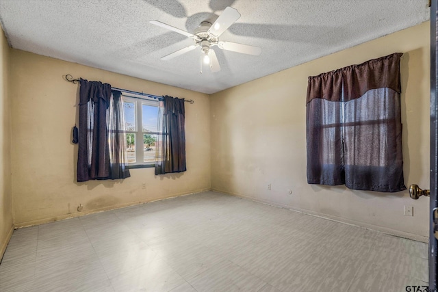 spare room with ceiling fan and a textured ceiling