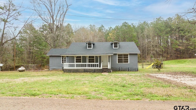 cape cod home featuring covered porch and a front lawn