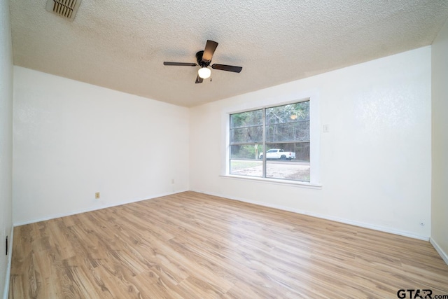 unfurnished room featuring ceiling fan, a textured ceiling, and light hardwood / wood-style flooring