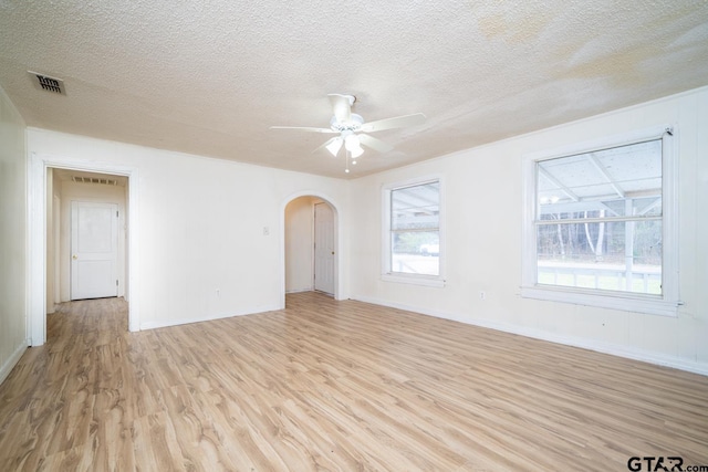 spare room featuring ceiling fan, a textured ceiling, and light hardwood / wood-style flooring