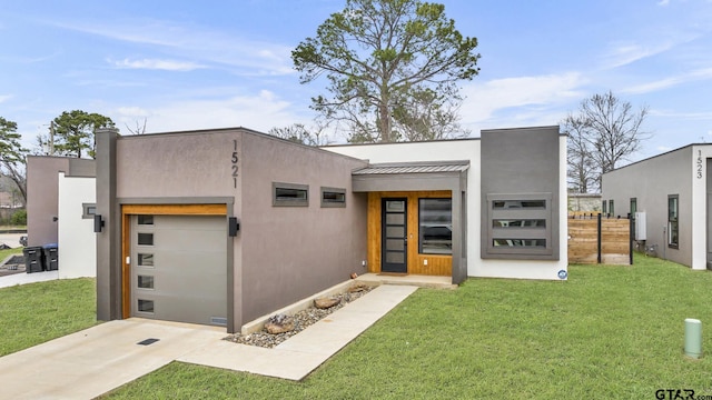 contemporary home with a front yard, a standing seam roof, an attached garage, stucco siding, and metal roof