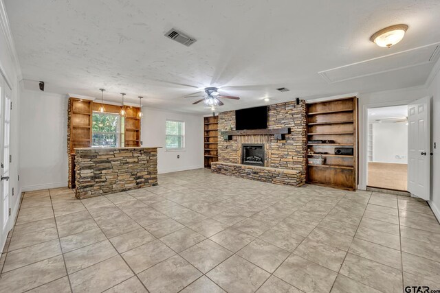 2010 County Road 4250, Winnsboro, TX 75494 - unfurnished living room featuring ceiling fan, attic access, built in shelves, a fireplace, and baseboards