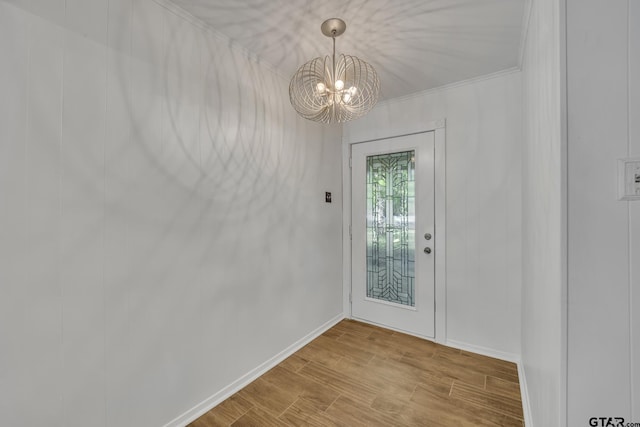 2010 County Road 4250, Winnsboro, TX 75494 - entryway featuring a chandelier, wood finished floors, baseboards, and ornamental molding