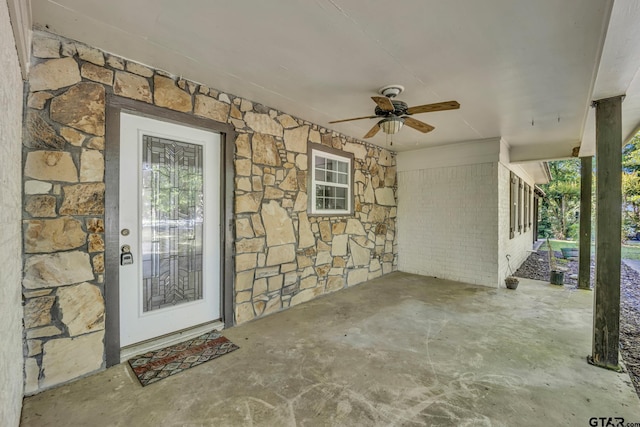 2010 County Road 4250, Winnsboro, TX 75494 - doorway to property featuring stone siding, ceiling fan, and a patio
